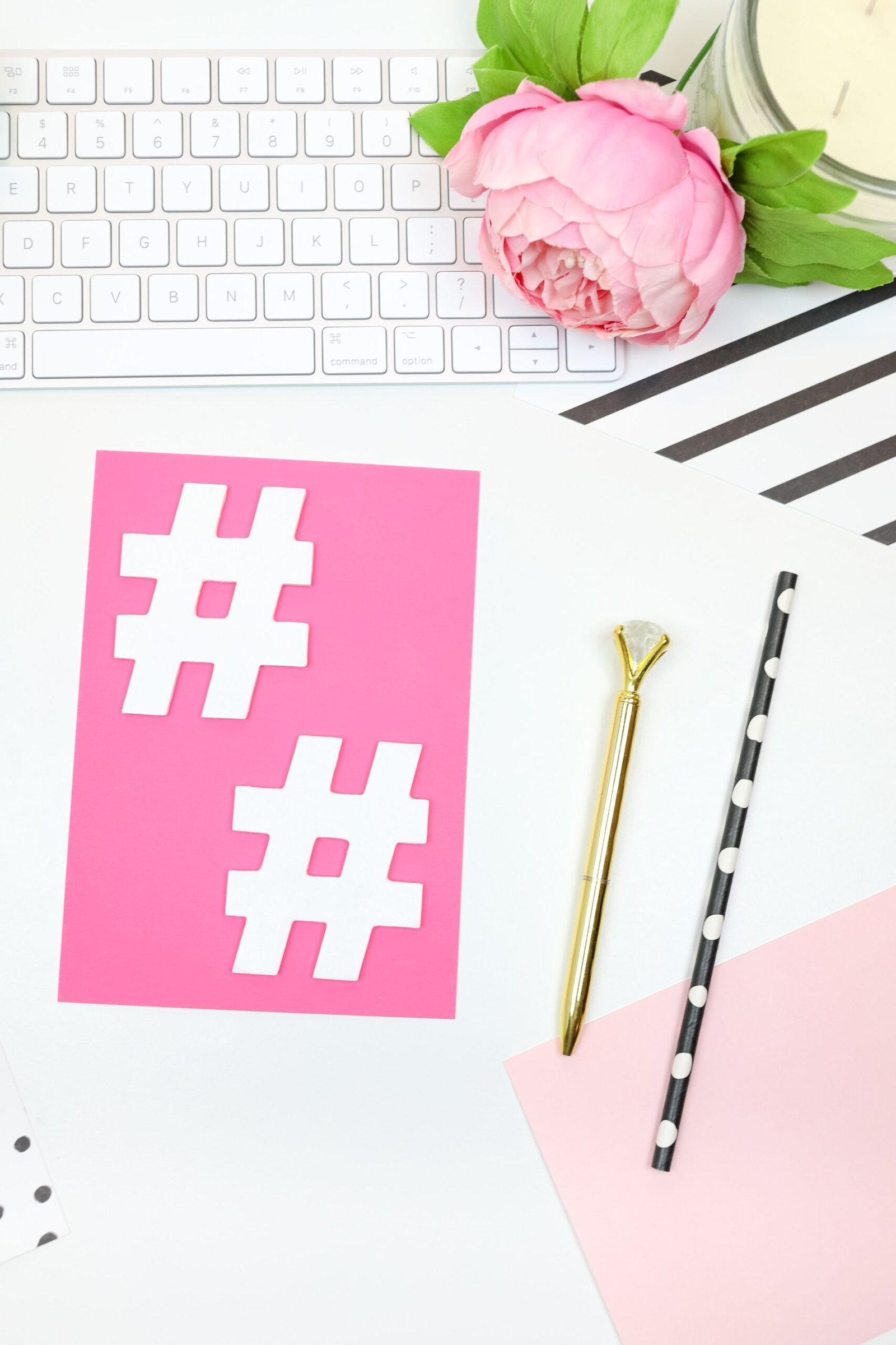 pink and white heart print card on white and gray computer keyboard